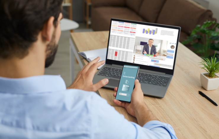 man on computer and cell phone